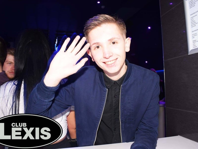 Waving? Or trying to get the bar staff's attention?