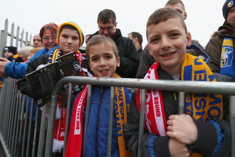 Two young fans eagerly anticipate the arrival of Liverpool's big name players.