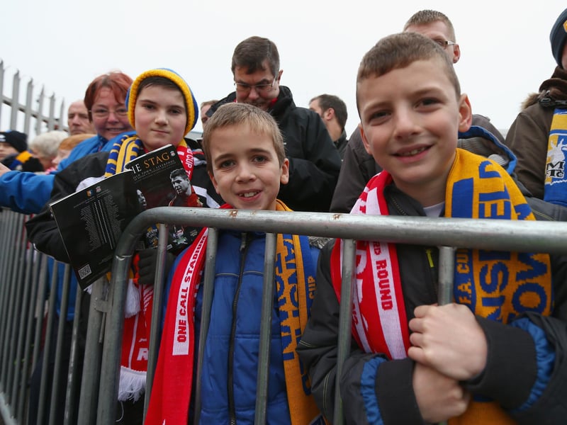 Two young fans eagerly anticipate the arrival of Liverpool's big name players.