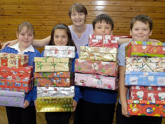 Pupils at Sutton's Dalestorth Primary School collecting parcels for the Operation Christmas Child appeal. Over 60 parcels have been collected for the project. run by the Samaritan's Purse project. Collecting the boxes was organiser Christine Foster.