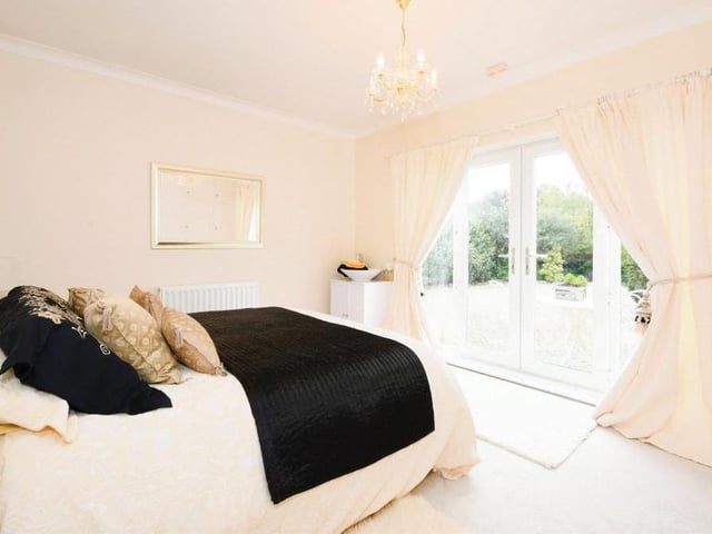 The third bedroom in the Lichfield Lane bungalow has access to the front garden, via a set of double-glazed French doors. It also boasts a wash hand basin, fitted wardrobes and coving to the ceiling.