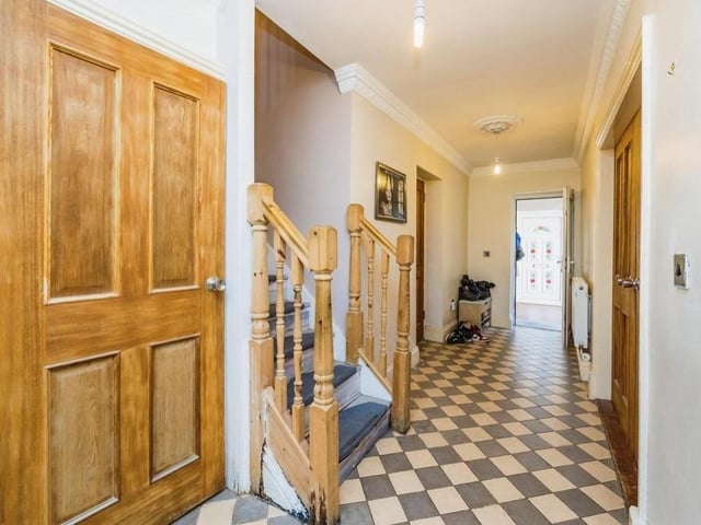 Before we go upstairs, let's pop into the entrance hall, which is distinguished by its tiled floor. It gives access not only to the staircase but also to the property's integral double garage.