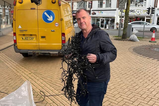 Coun David Hennigan starts the job of unravelling over 200 metres of Christmas Lights to go up in Portland Square, Sutton