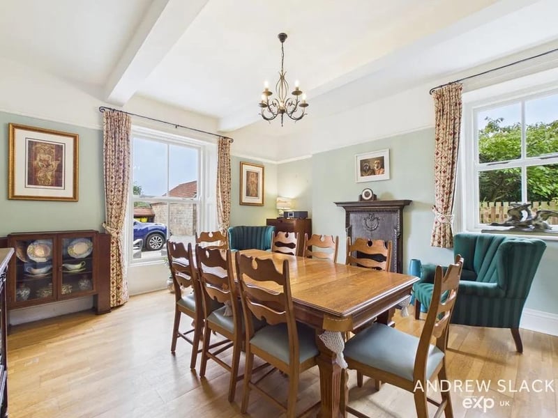 The formal dining room with open fire, beams and sash windows is the perfect place for family meals or entertaining.