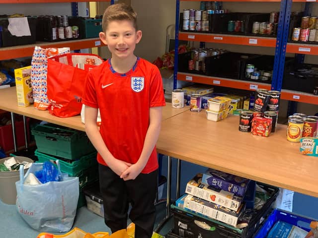 Archie Wallis, 9, with his donations for Eastwood Food Bank.