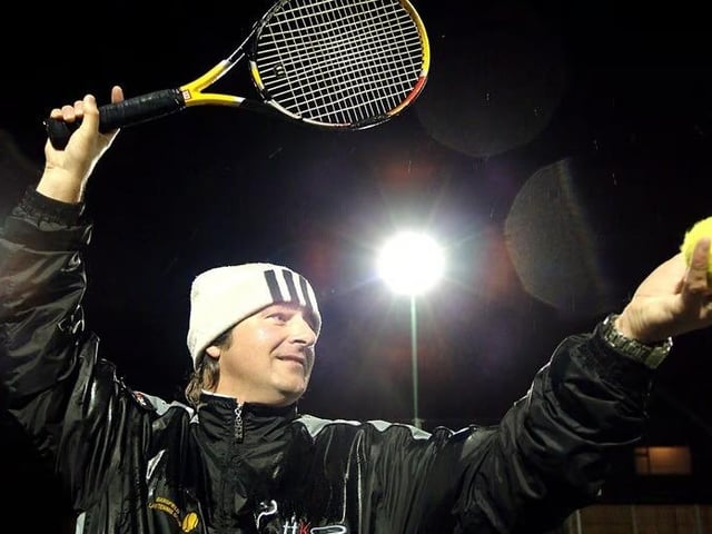 Tennis coach Dave Waring braved the rain to test out the new flood lit tennis courts at the Lawn Club.