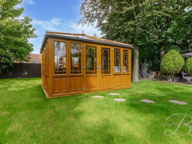 The garden features this additional conservatory that contains a hot tub.
