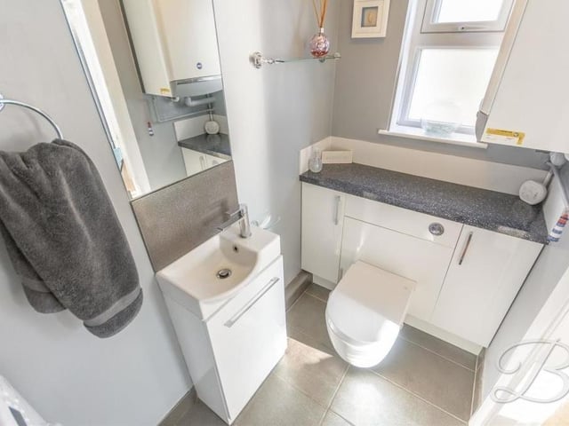 The other end of the downstairs toilet/utility room, housing a wash hand basin and a low-flush WC.