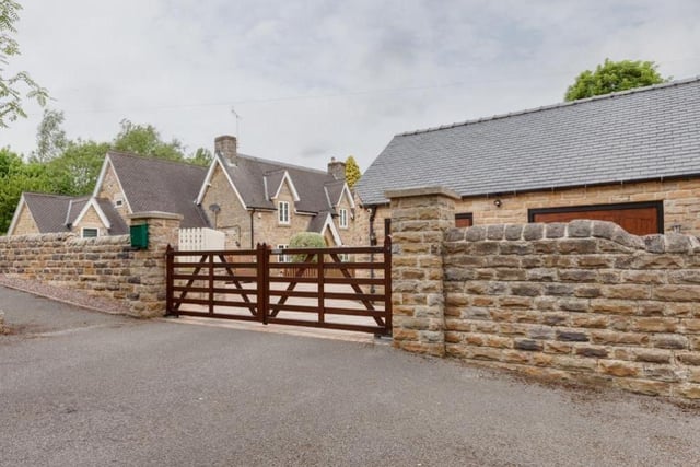 From Main Road in Heath, the £950,000 property can be accessed via these double timber gates.