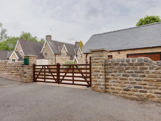 From Main Road in Heath, the £950,000 property can be accessed via these double timber gates.