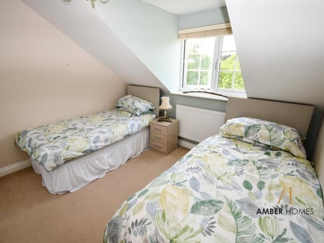 All four bedrooms create a sanctuary of comfort, including this one, which has space for twin beds.