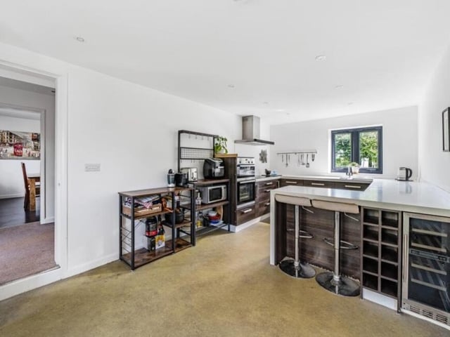 The kitchen is full of modern appliances, and its layout would invite the new owners of the cottage to put their personal stamp on it.
