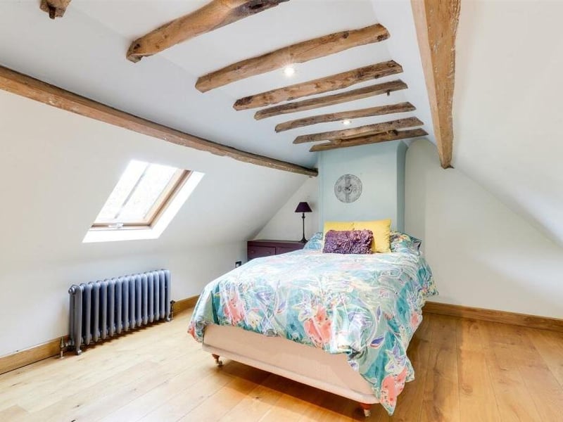Time to go up to the second floor of the £550,000 Linby cottage now to find two more spacious double bedrooms. This one benefits from a solid-oak floor, a vaulted ceiling with exposed oak beams, recessed spotlights and a Velux window.