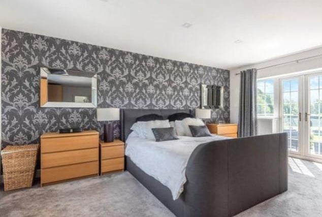 The property has four bedrooms in total. This modern bedroom is styled with it's own spacious balcony.