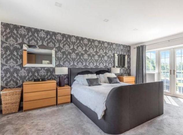 The property has four bedrooms in total. This modern bedroom is styled with it's own spacious balcony.