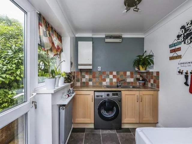 Just off the kitchen is this useful utility room, which has space and plumbing for a washing machine and tumble dryer. It is fitted with base units, incorporating a sink and drainer, plus vinyl flooring. A door leads to the beautiful back garden.