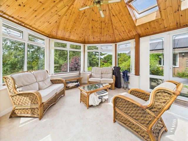Residents can enjoy a conservatory with a striking timber panelled ceiling