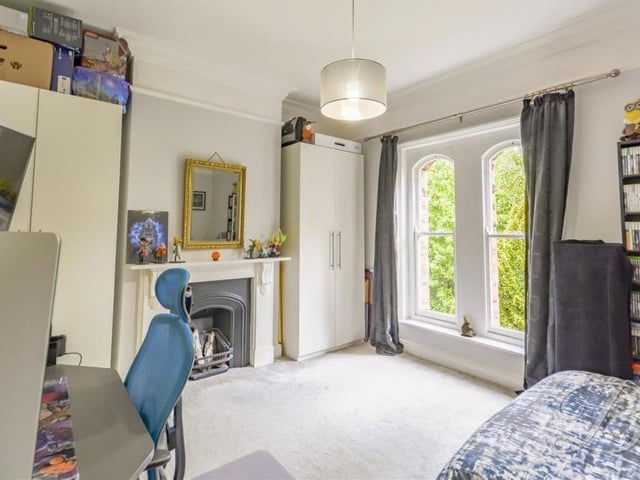 Like so many rooms at the Crow Hill Drive property, this bedroom has retained original features, such as the fireplace. The attractive windows face the front.