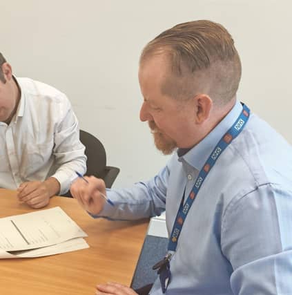 An employment specialist speaking with a service user.