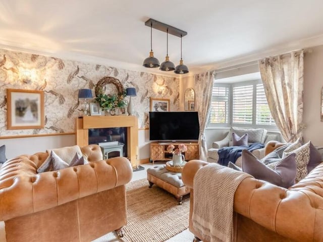 The first of four reception rooms on the ground floor is this lovely, bay-fronted lounge, which offers comfort and style. Its main feature is a granite fireplace with hearth and hand-made, solid oak surround.