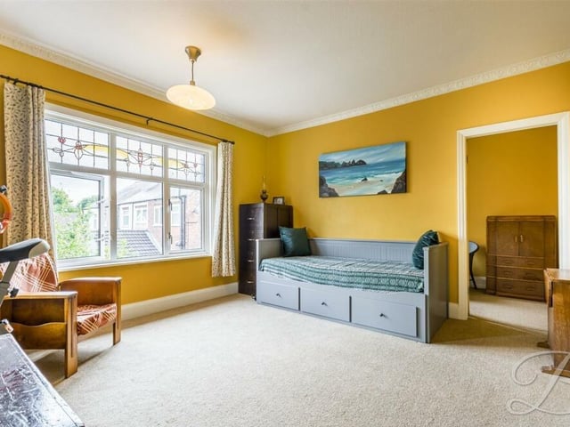 On to the next bedroom, which is also a good size. With a carpeted floor and coving to the ceiling, it faces the front of the £400,000 Jacksdale property.
