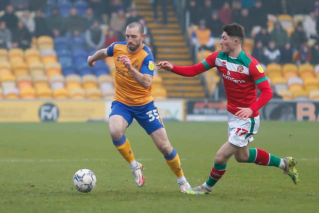Mansfield Town midfielder John-Joe O'Toole fends off Walsall midfielder Jack Earing. Photo by Chris Holloway / The Bigger Picture.media