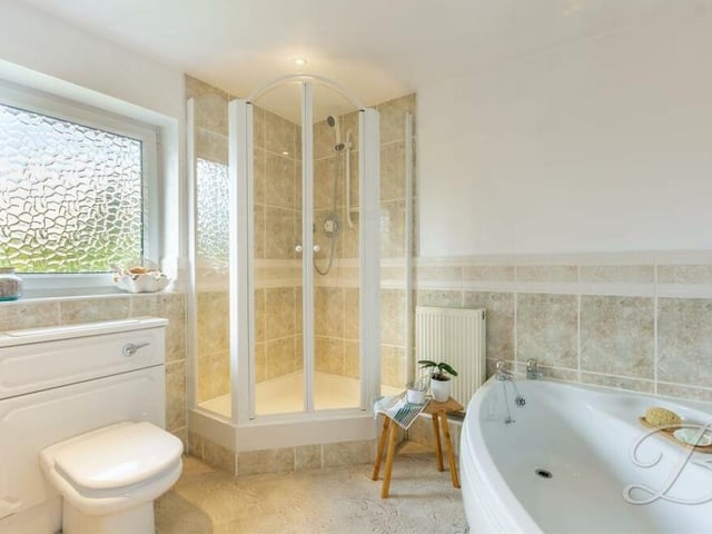 As well as the bedrooms, the first floor of the Mansfield property houses this family bathroom. It comprises a walk-in shower cubicle, separate corner bath, low-flush WC and vanity wash hand basin.