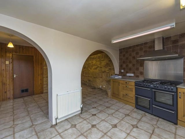 These striking archways are an eyecatching feature of the open-plan kitchen and guide you to a dining area and extra living space.