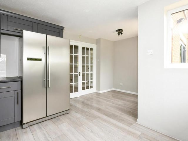 A second shot of the kitchen, with its fridge freezer. The whole room's appearance is very striking.