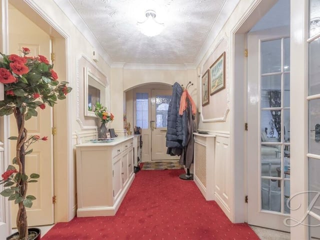 As we prepare to go upstairs, let's pass through the entrance hall, which has fitted carpets, storage space and a central heating radiator, as well as the staircase.