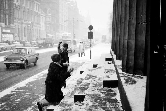 Two boys have a snowball fight on Princes Street in 1962.