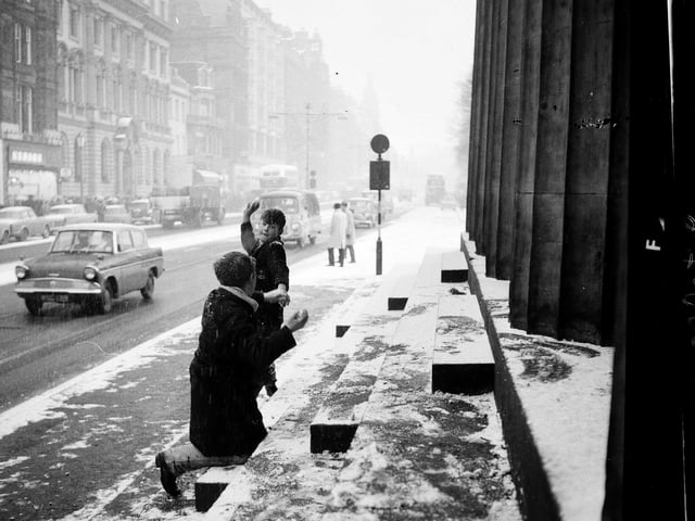 Two boys have a snowball fight on Princes Street in 1962.