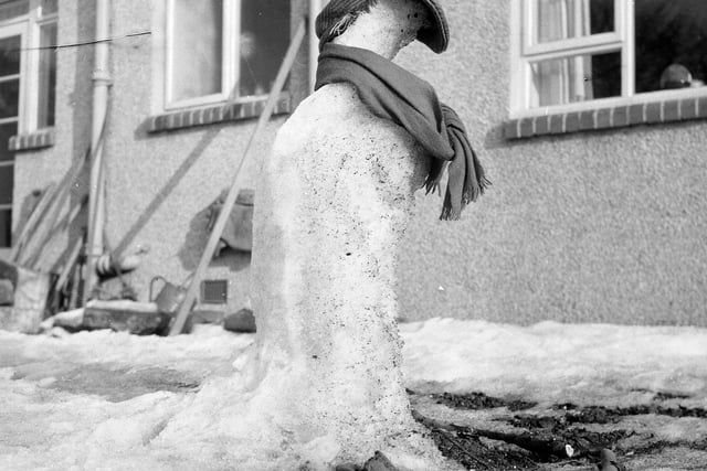 A snowman, complete with bunnet and scarf, melting in a Corstorphine garden in 1963.