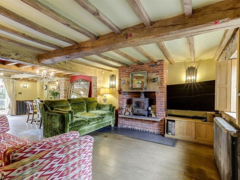 Although the cottage is more than 200 years old, its sympathetic restoration has created a bright and spacious ground floor. Here you can see how the living room gives open access to the dining room.