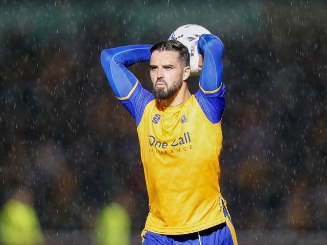 Stephen McLaughlin takes the throw in the rain against Northampton Town in the play-off semis.