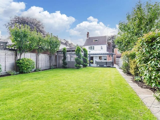 A well-maintained garden surrounds the house, providing a lovely outdoor space for children to play or for hosting summer barbecues.