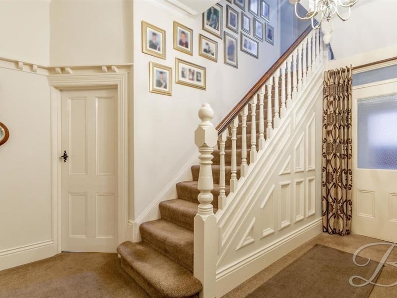 As we prepare to go upstairs, let's take a quick look at the inviting entrance hallway. As well as stairs leading to the first floor, it also has access to the property's garage.