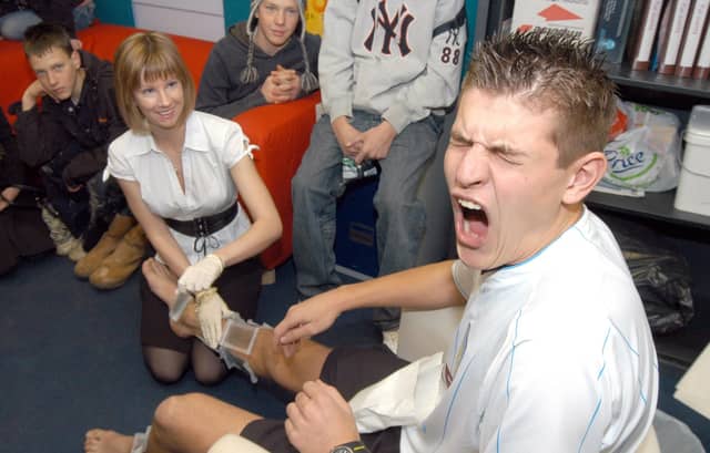 Dean Lambert, President of the West Notts College Students Union winces during the leg wax for Children in Need. Carrying out the torture was Rebecca Short. Year: 2007.