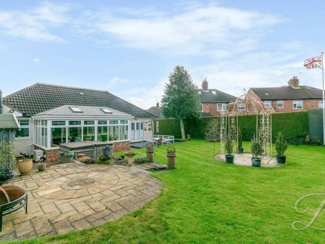 The well-established back garden has been beautifully landscaped and features a decorative paved area.