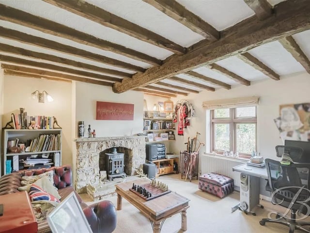 The  sitting room benefits from a feature log burner.