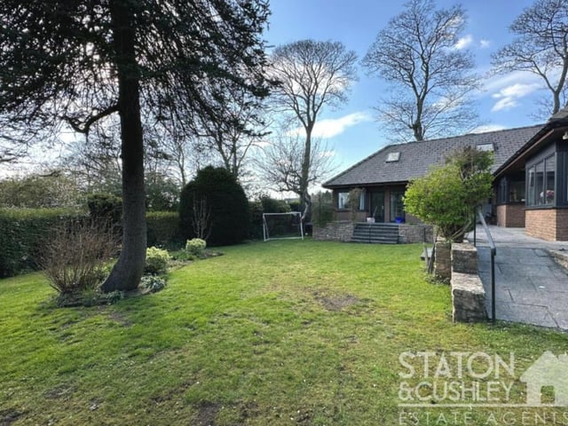 The well-maintained garden at the back of the property is suitable for relaxation or playtime.