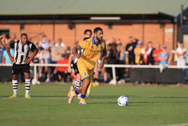 Tyler Roberts slots home the winning penalty.