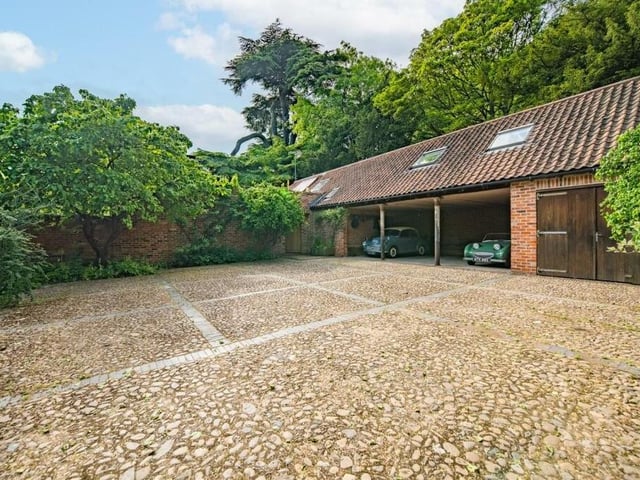 Here is a close-up of the outbuildings, including the garage, and also ample off-street parking space.