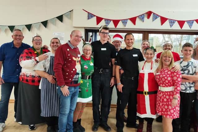 Two Sutton police officers made the most of working on Christmas Day by helping to serve dinner at a community centre.