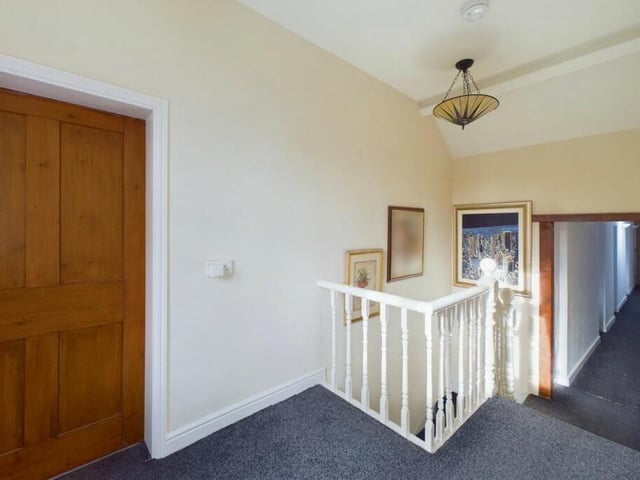 At the top of the stairs, you are greeted by this first-floor landing, which leads to all five bedrooms.