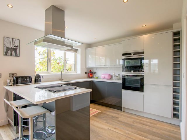 The kitchen has a breakfast bar an integral appliances.