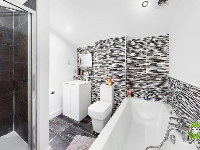 The family bathroom is well presented, with modern tiling and white units.