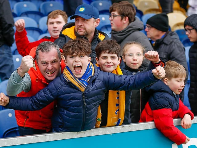 Mansfield Town fans watch the match against Northampton Town.