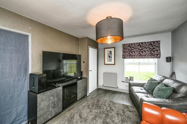 A second reception room on the ground floor is this cosy lounge, which faces the front of the property. Features include a laminate floor, a storage cupboard and an archway leading to the kitchen/diner.