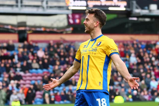 Rhys Oates celebrates during the English FA Cup fourth round football match between Burnley and Mansfield Town at Turf Moor in Burnley on February 14, 2026. (Photo by Paul Currie / AFP via Getty Images)